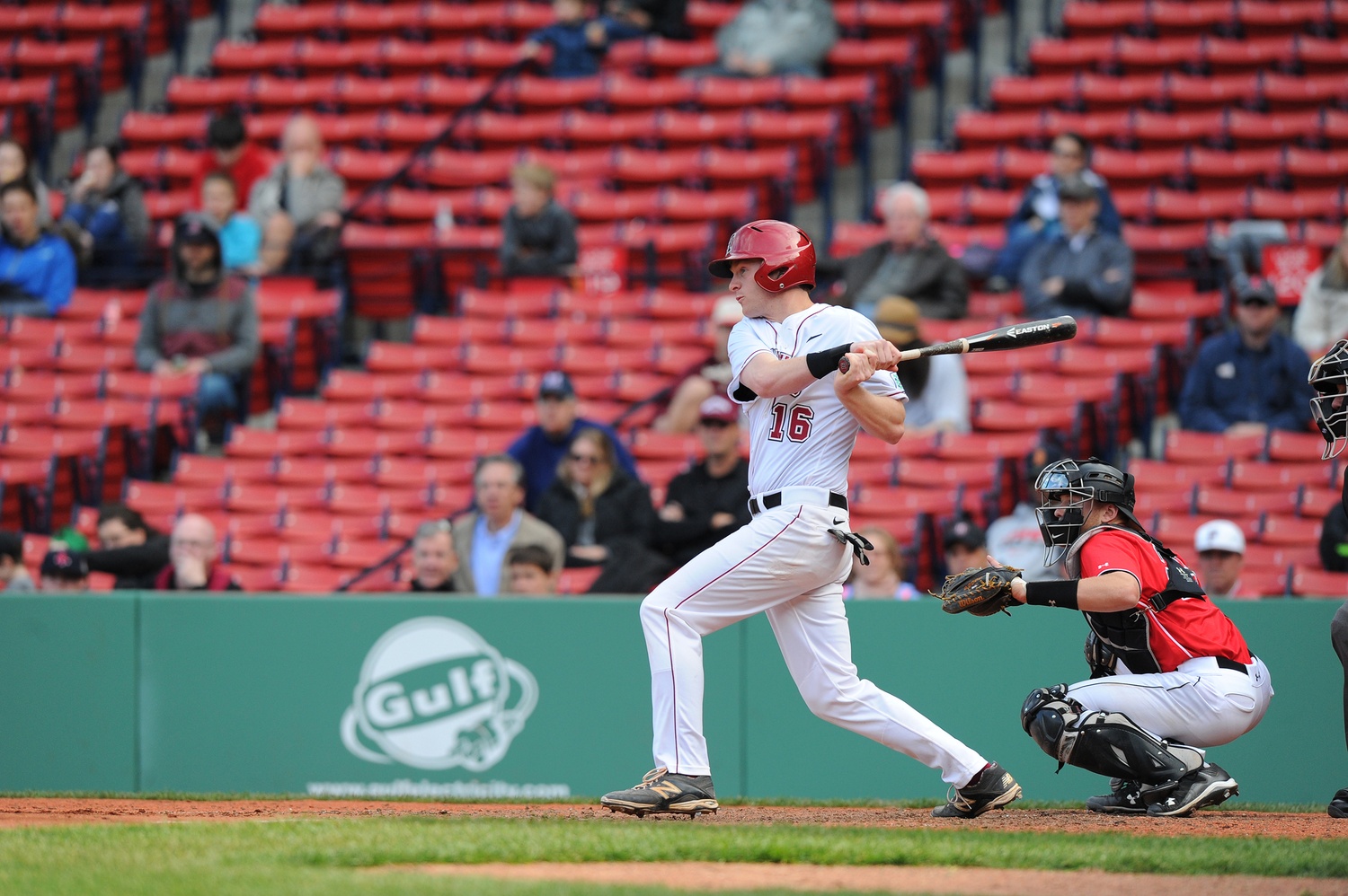 Jake McGuiggan '15 hits a home run over the Green Monster at Fenway during the Baseball Beanpot. McGuiggan now serves as a Bench Coach for the Toronto Blue Jays' affiliate team, the Double-A New Hampshire Fisher Cats.