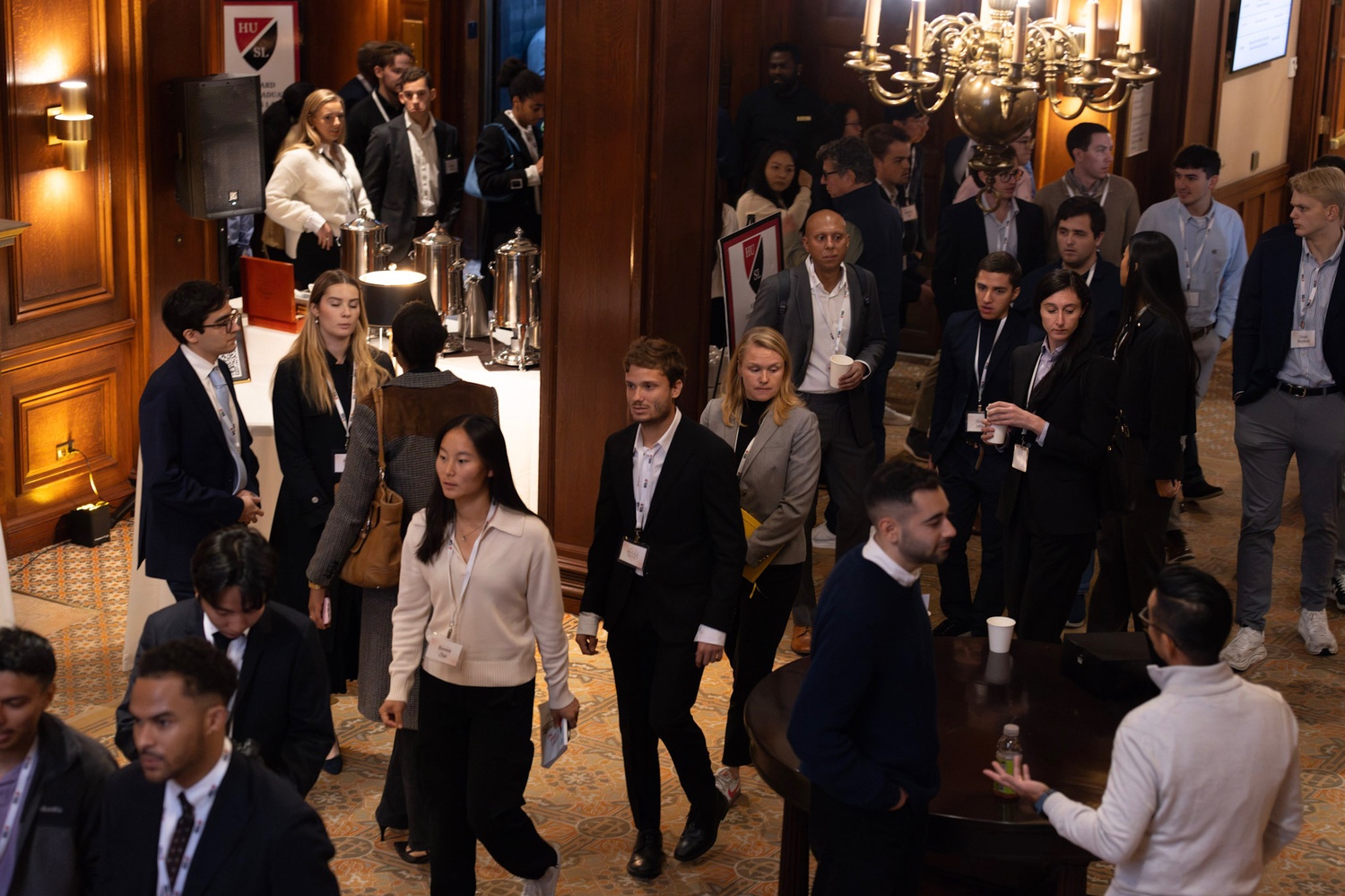 Conference attendees congregate in the Harvard Club of Boston's lobby between speakers.
