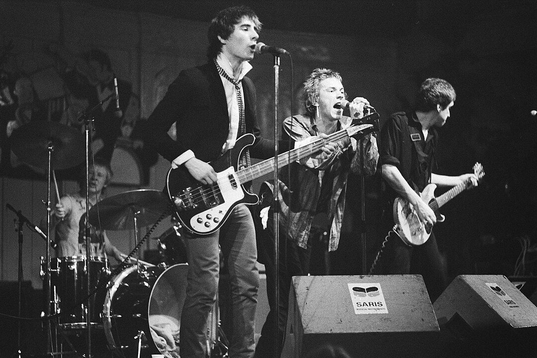 The Sex Pistols performing in Amsterdam in January 1977. Left to right: Paul Cook (behind the drums), Glen Matlock, Johnny Rotten, and Steve Jones.
