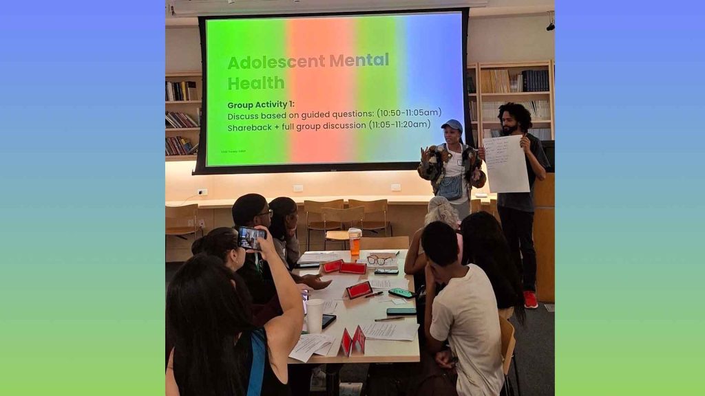 Students from The New School's Center for Global Mental Health share resources with caregivers in a training session