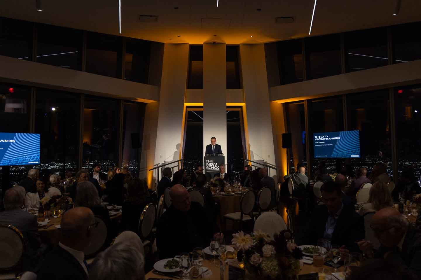A speaker at a podium addresses an audience at the banket for the New School City Visionary Awards