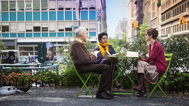 People sit around a table outside at Union Square.