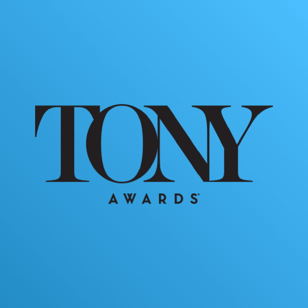 Il tappeto rosso di notte, illuminato da luci intense, che conduce all’ingresso della cerimonia degli Olivier Awards 2023.