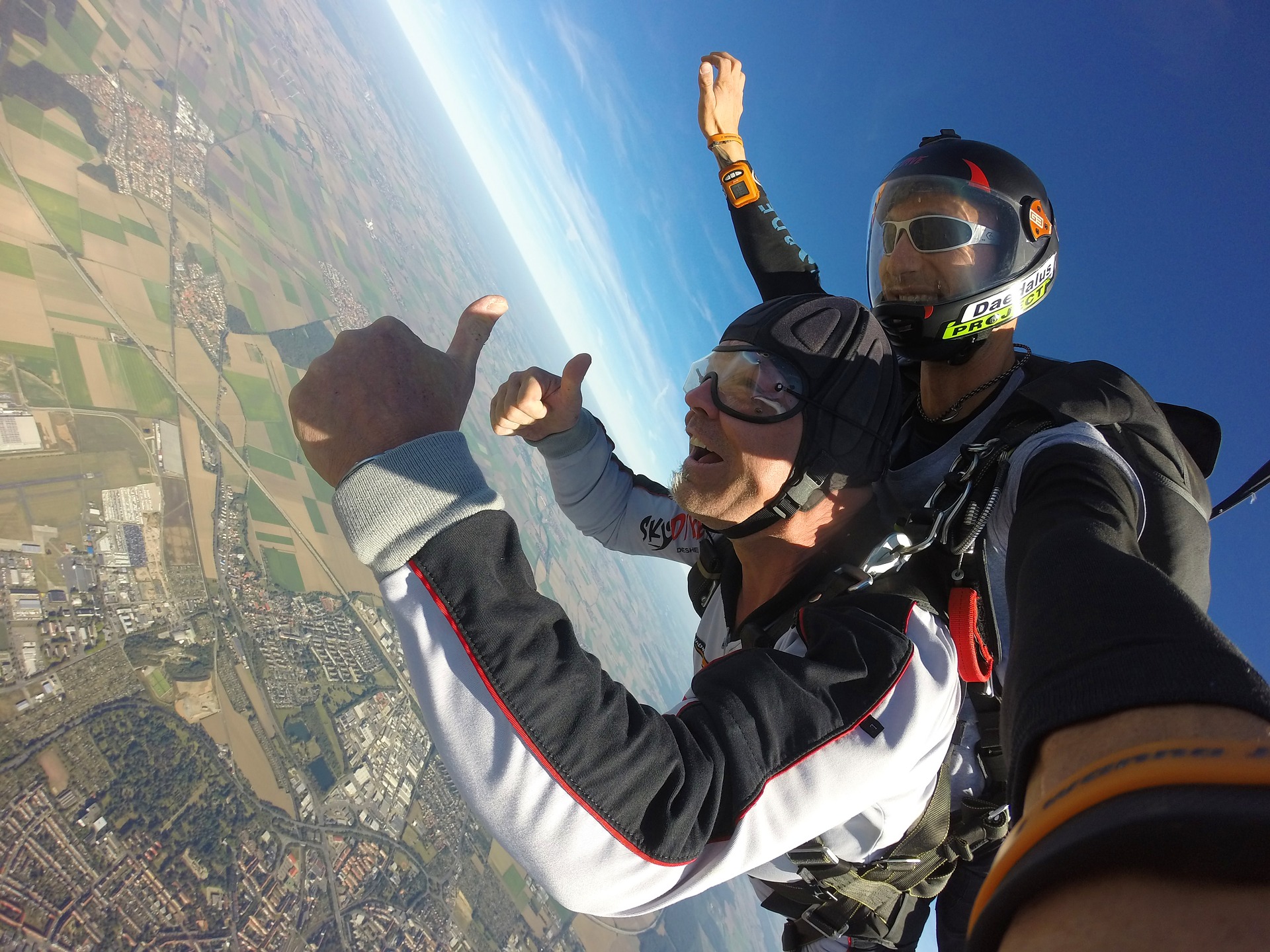Skydiver descending over Perth with city skyline and Swan River in view.
