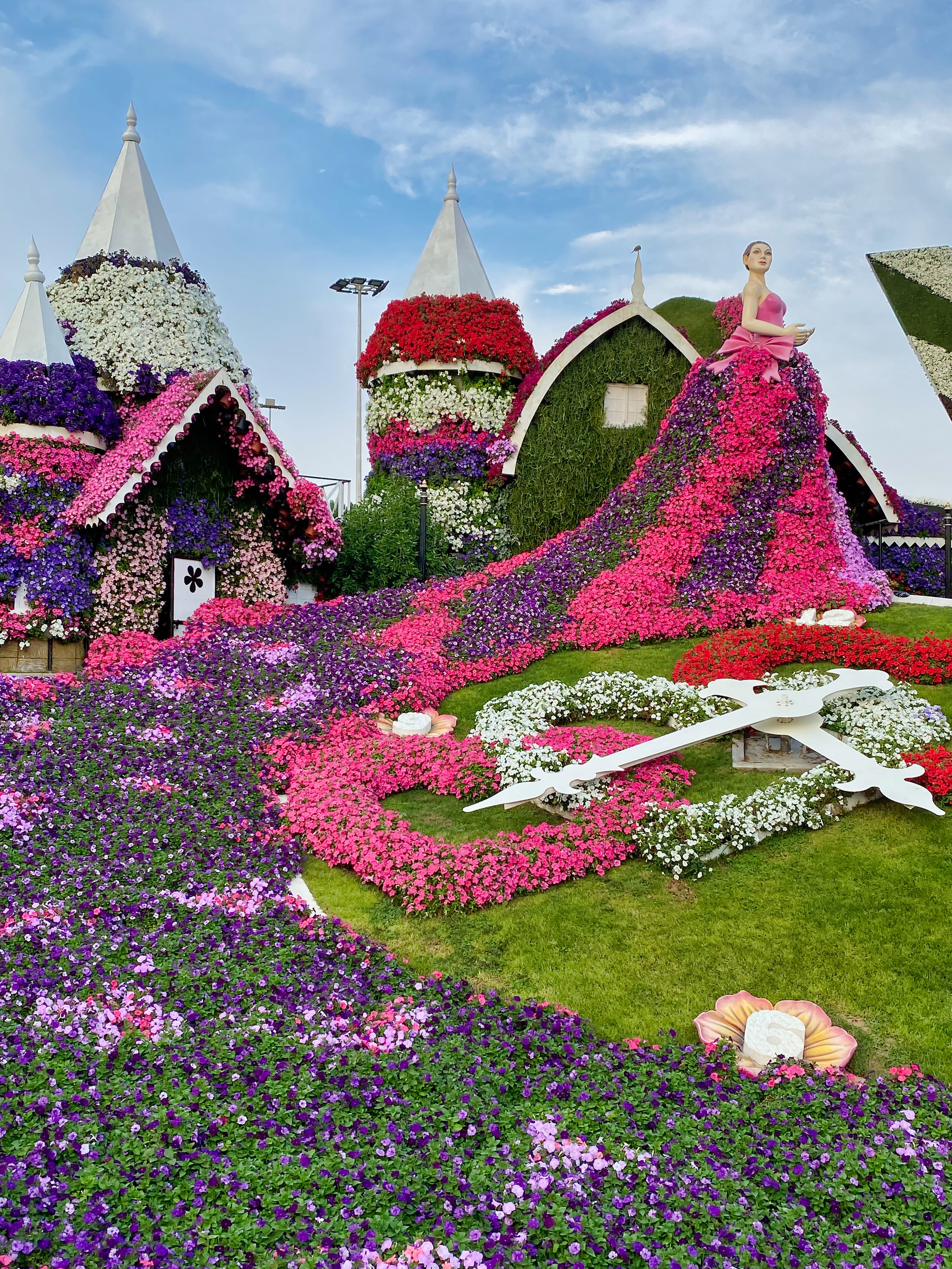 Dubai Miracle Garden floral clock and flower-covered houses.