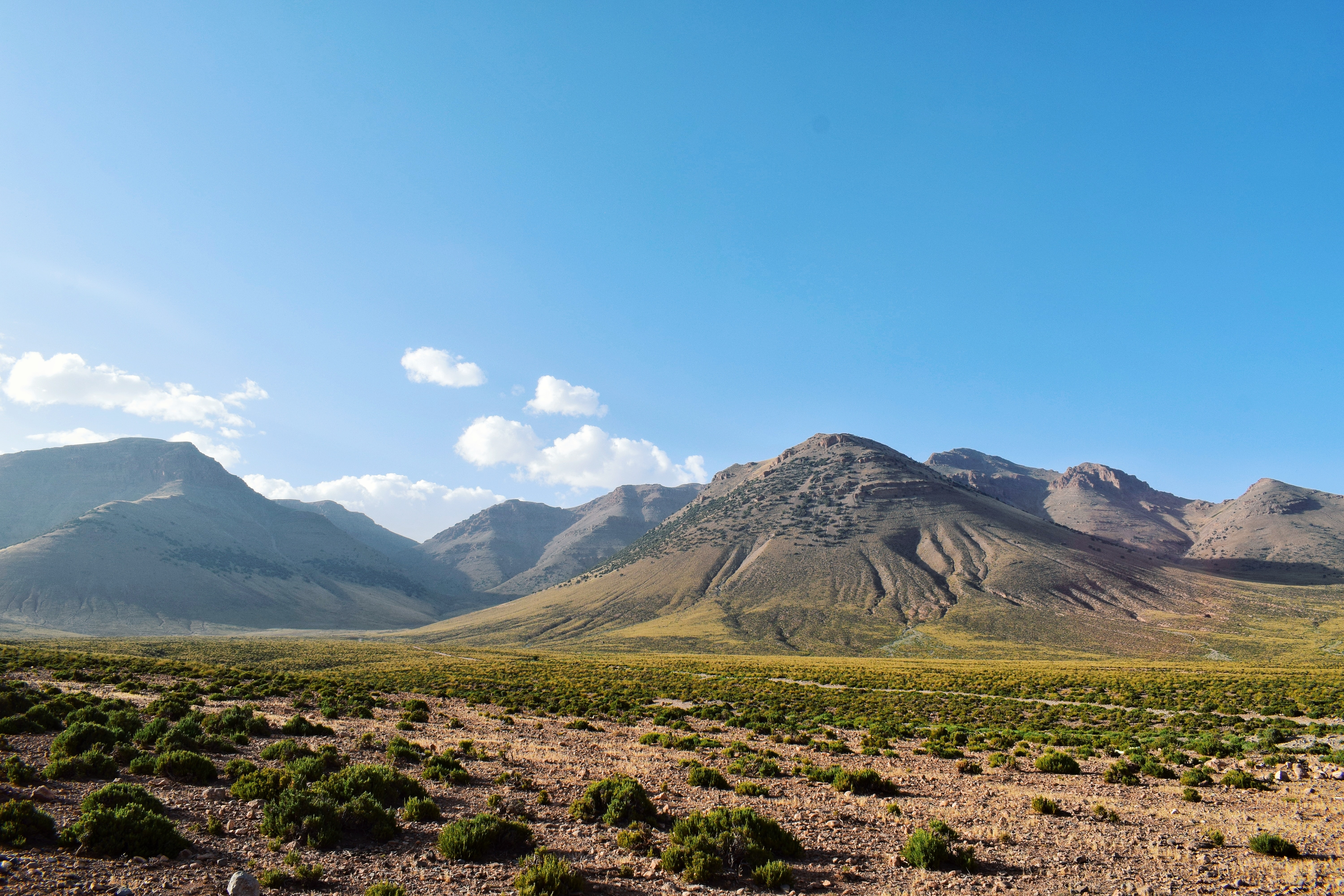 Atlas Mountains landscape with rugged peaks and clear blue sky.