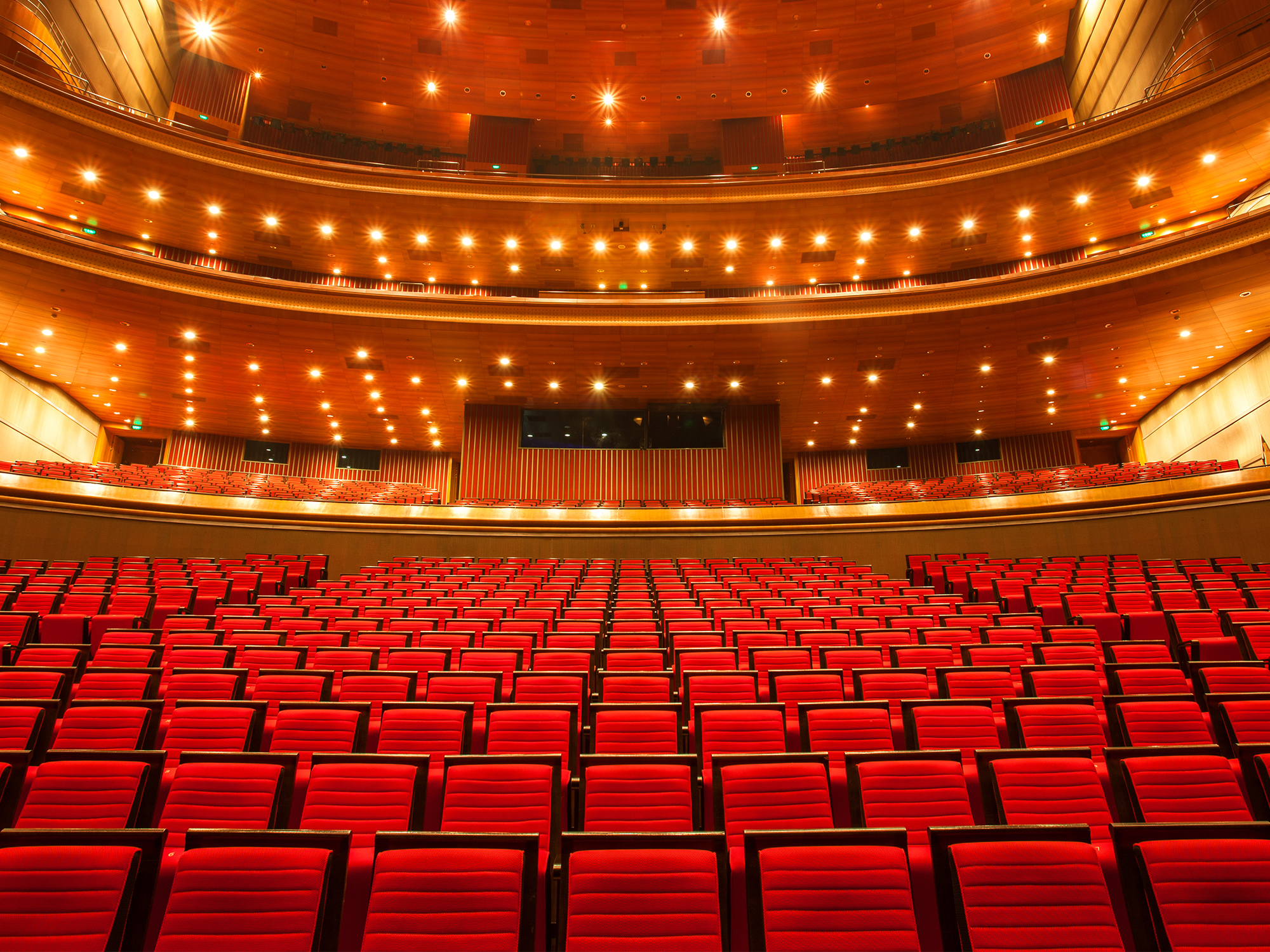 Interno del teatro di Broadway con file di poltrone rosse.