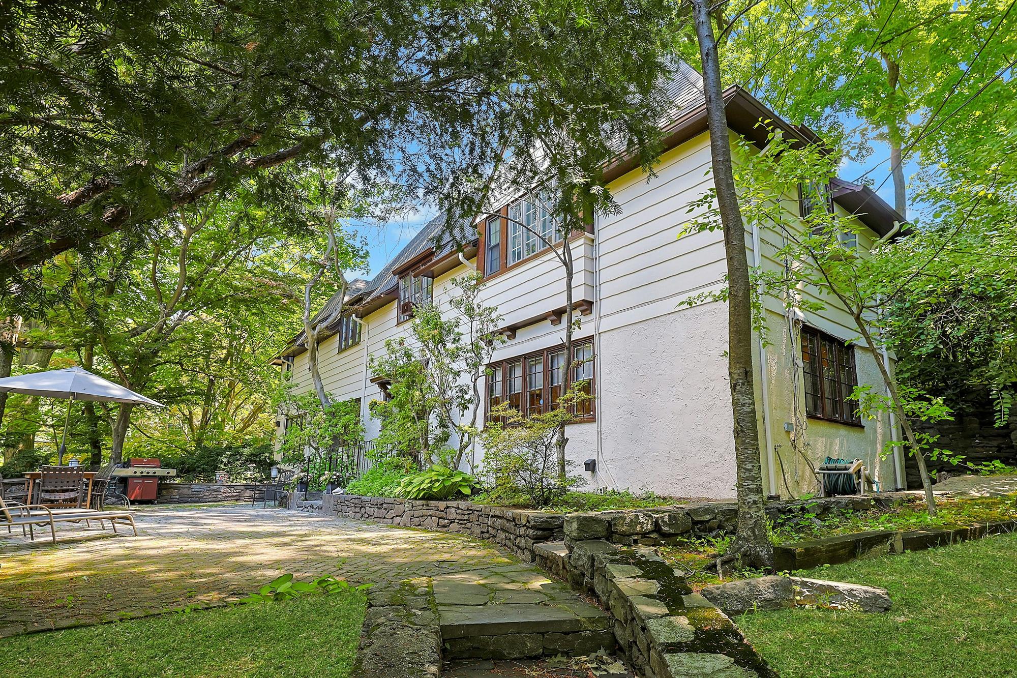 Classic & Spacious 5-Bd. Center-Hall Medieval Revival-Style House with Patio & Grassy Yard