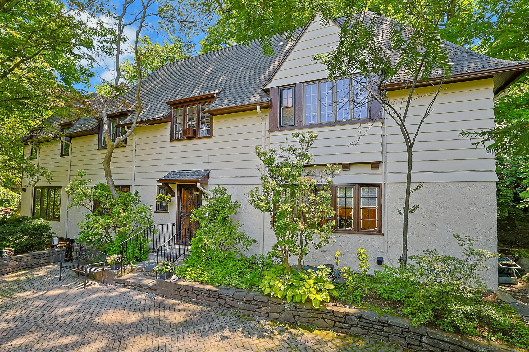 Classic & Spacious 5-Bd. Center-Hall Medieval Revival-Style House with Patio & Grassy Yard