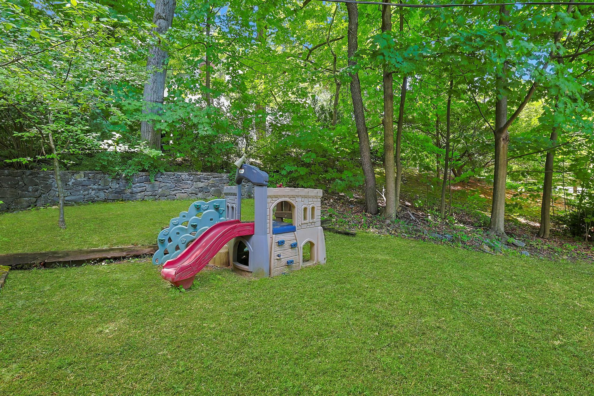 Classic & Spacious 5-Bd. Center-Hall Medieval Revival-Style House with Patio & Grassy Yard