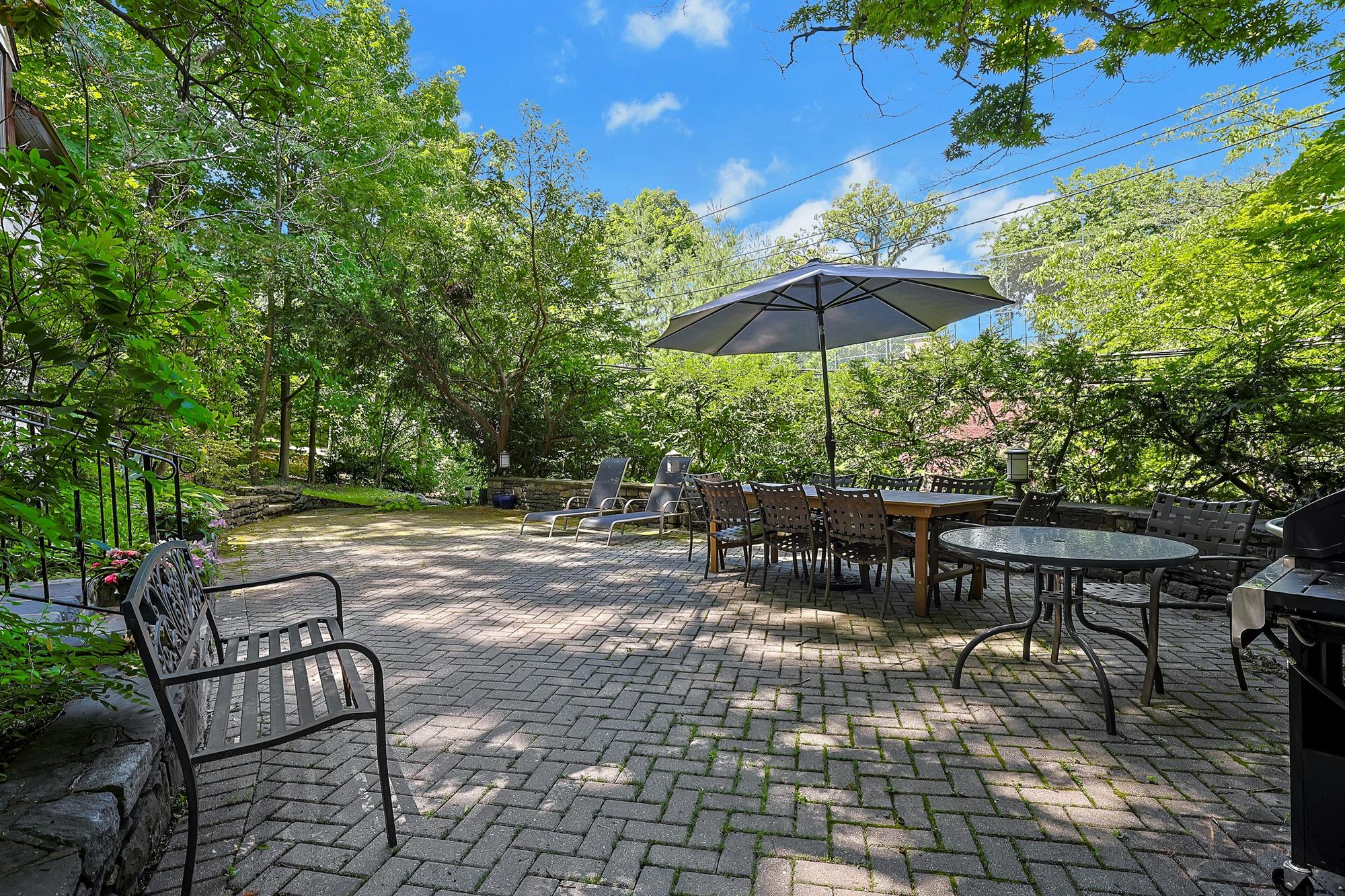Classic & Spacious 5-Bd. Center-Hall Medieval Revival-Style House with Patio & Grassy Yard