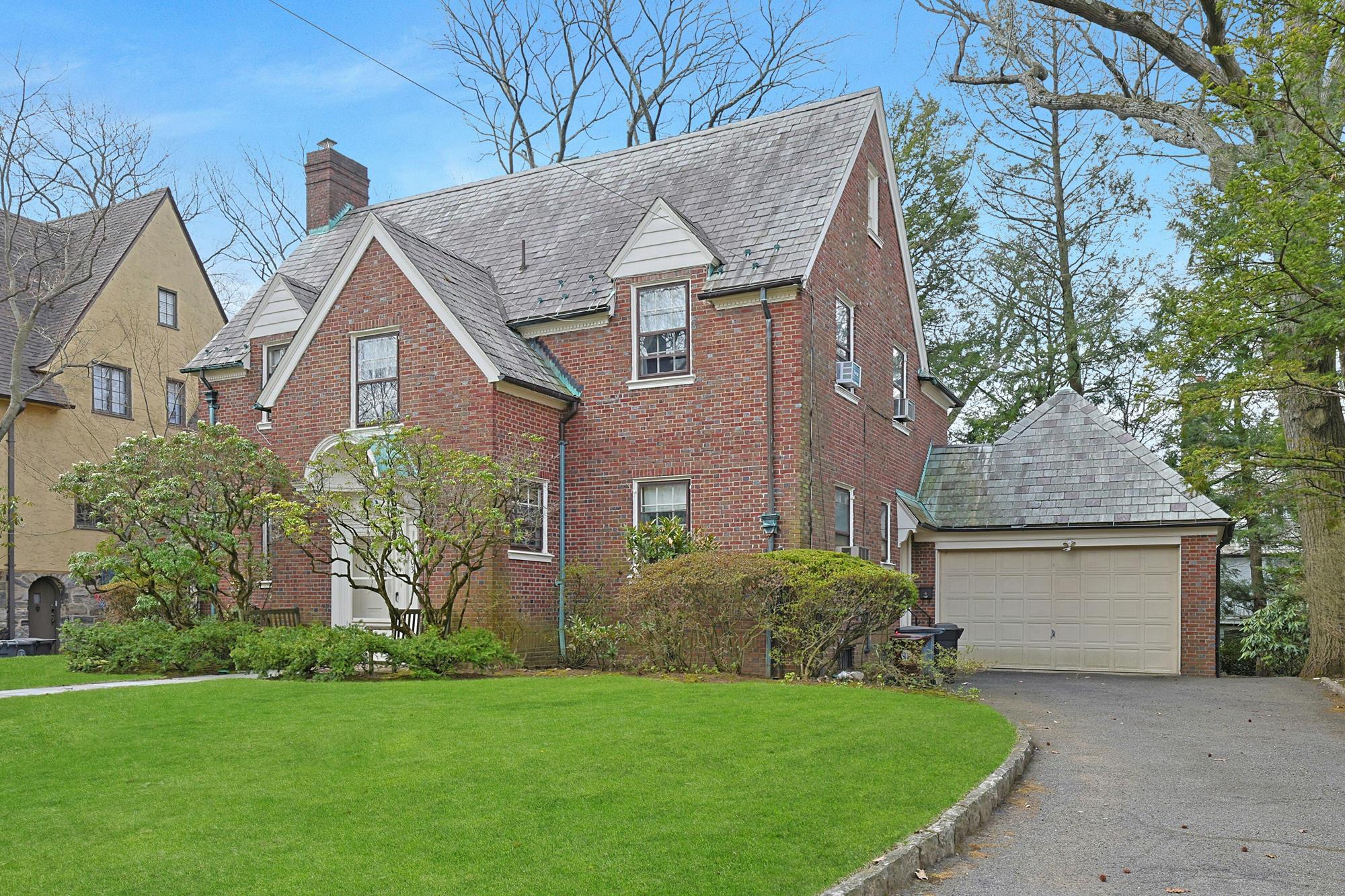 Classic & Spacious 4-Bd. Brick Center-Hall Colonial with Porch & Grassy Yards