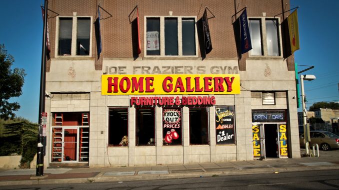 Joe Frazier’s gym, which was converted to a furniture store, sits on North Broad Street near Glenwood Street. An architecture professor and students have been fighting to preserve the late boxing legend’s gym. ( TIMOTHY VALSHTEIN / TTN ) Joe Frazier’s gym, which was converted to a furniture store, sits on North Broad Street near Glenwood Street. An architecture professor and students have been fighting to preserve the late boxing legend’s gym. ( TIMOTHY VALSHTEIN / TTN )