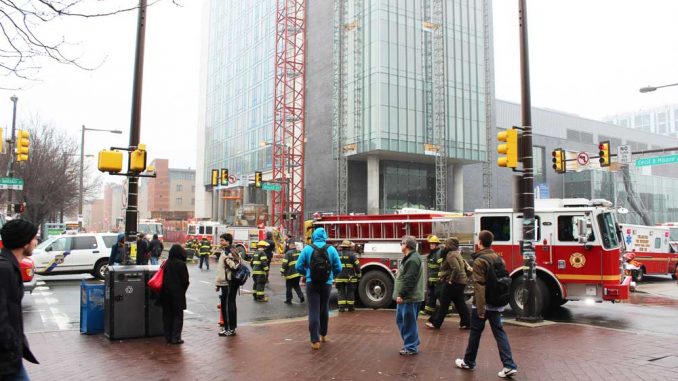 Morgan_Fire_AF-WEB Bystanders look on as firefighters contain a fire on the 18th floor of Morgan Hall. The $216 million, 27-story residence hall apparently received little damage from the fire. | ANGELO FICHERA / TTN