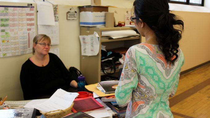 Senior Jennifer Nguyen (right) talks with local teacher Christine Swift as part of a high school journalism workshop. | Claire Sasko TTN Senior Jennifer Nguyen (right) talks with local teacher Christine Swift as part of a high school journalism workshop. | Claire Sasko TTN