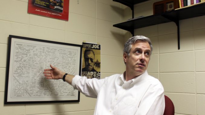 Joe Glennon, the faculty director of Diamond Edge Communications, motions to his favorite poster of Bruce Springsteen lyrics. Glennon’s work has always focused on copywriting. | Grace Wilson TTN Joe Glennon, the faculty director of Diamond Edge Communications, motions to his favorite poster of Bruce Springsteen lyrics. Glennon’s work has always focused on copywriting. | Grace Wilson TTN