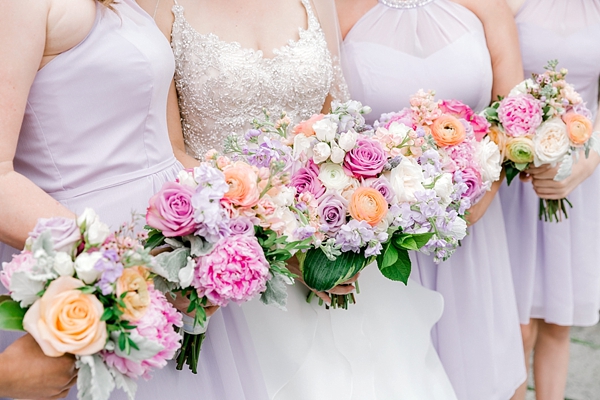 Pink and purple pastel wedding bouquets with ranunculus and peonies