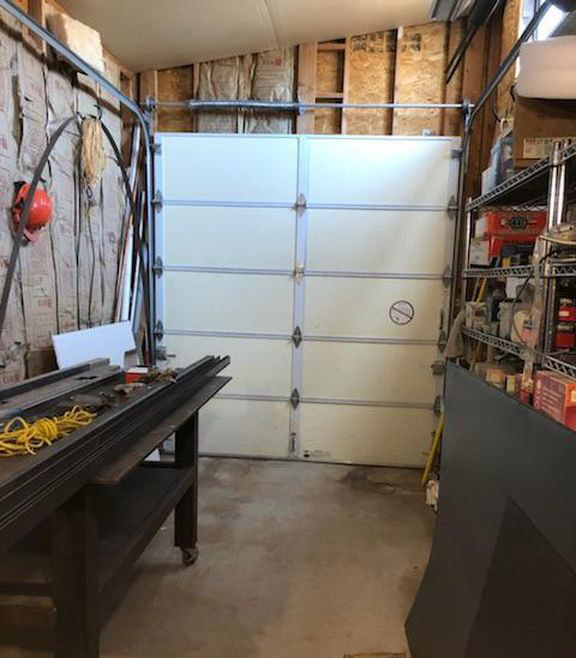 What are the signs that my garage door needs repair?