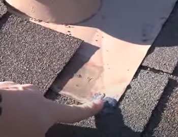 well sealed nail holding metal flashing to rooftop