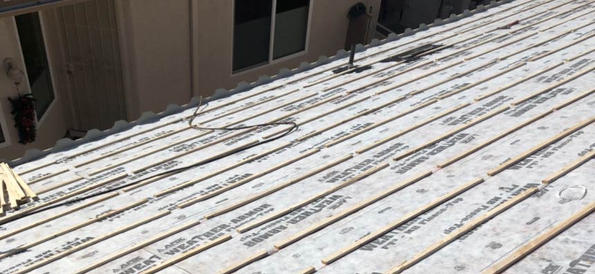 roofing contractor Tucson Tucson roofing company installing a tile roof