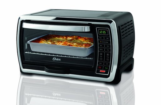 Image shows a Oster large capacity toaster oven on a white counter.