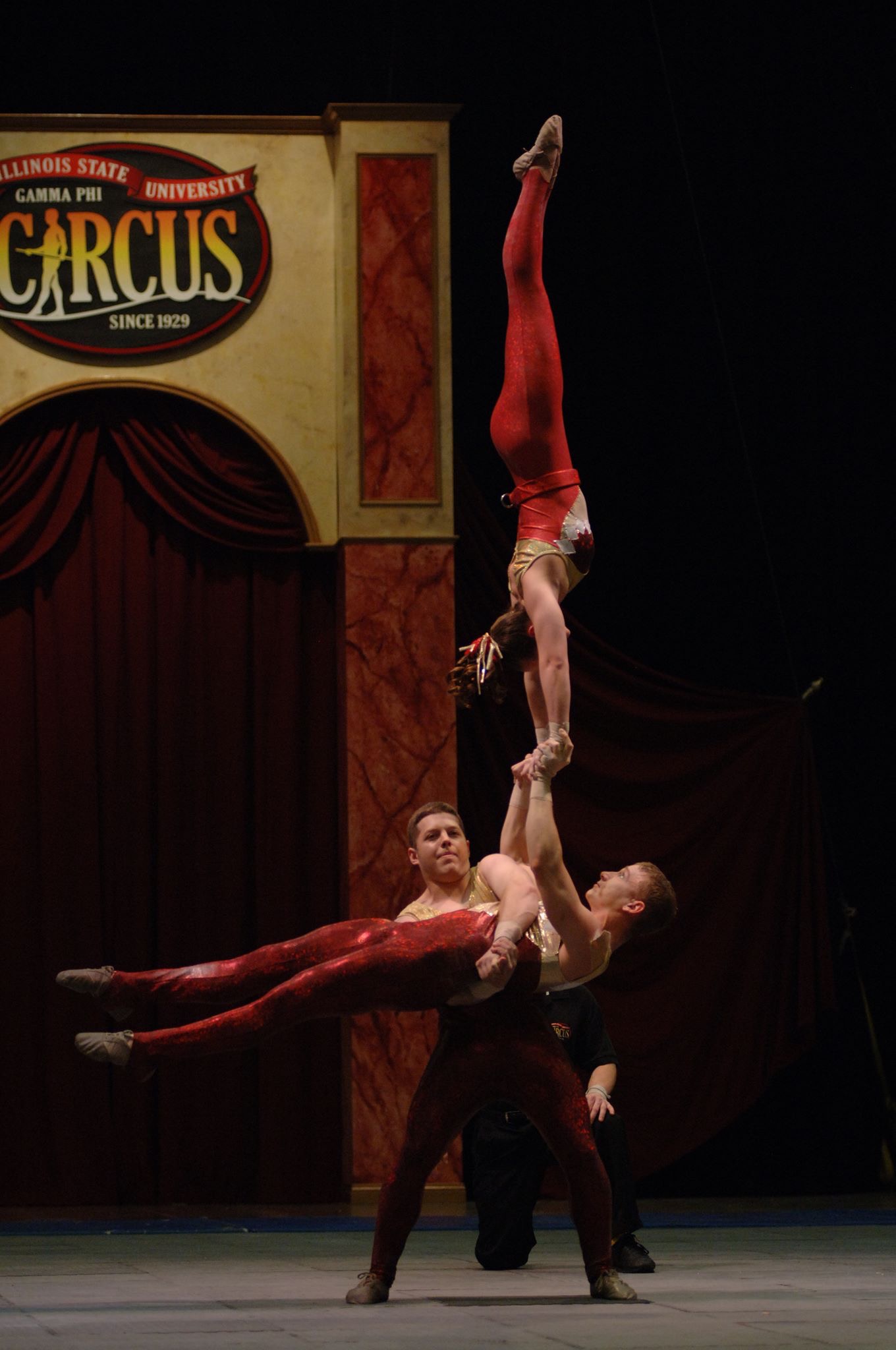 Rebecca Nemecek performing hand balancing in the Gamma Phi Circus at Illinois State University. Rebecca's husband is the base (holding her and the other performer).
