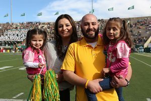 Josh Romero, his wife, Vanessa, and their two girls enjoy the CSU game