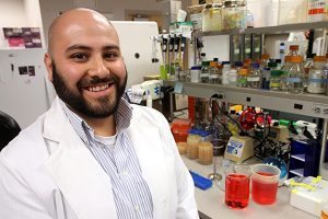 Josh Romero, a senior in biochemistry at Colorado State University, works on DNA repair research in the Molecular Genetics building on campus. Photo by Kati Blocker, UCHealth.