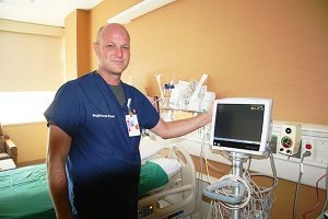 Tim Pratt, nurse manager on the Medical Surgical Progressive Care Unit, shows one of the recently installed telemetry monitors that now make progressive care available in all 36 rooms.