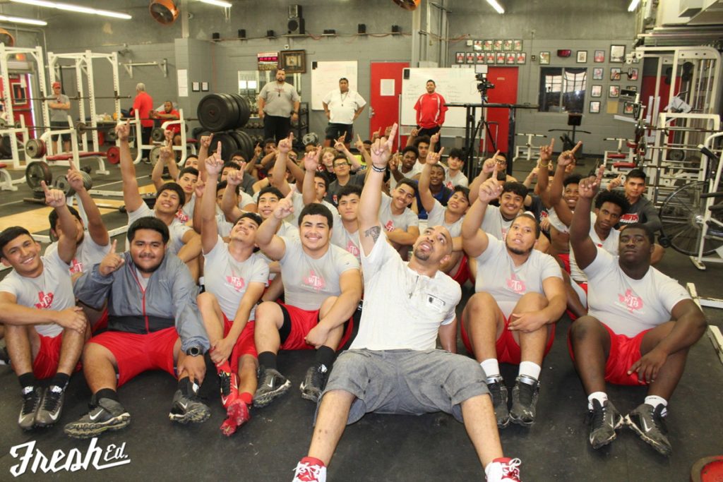 Former NFL player Bo Scaife now works with younger players to serve as a mentor and help them overcome injuries. He is photographed in front of a group of young men. Photo courtesy of Bo Scaife.