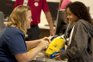 In this photo, eleven-year-old Kya Franklin, right, gets Denver Nugget's Rocky the Mountain Lion stitched up at UCHealth Longs Peak Hospital in Longmont.