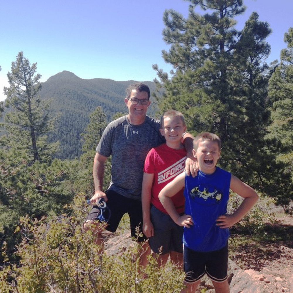 Leland Fay is pictured hiking in the mountains with his two sons.