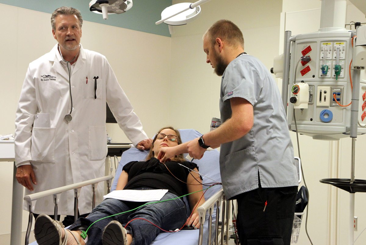During a training exercise, Dr. Jamie Teumer, medical director of the UCHealth Longs Peak Hospital ER, and a nurse practice caring for a pregnant gunshot vicitm who is laying on a hospital bed.