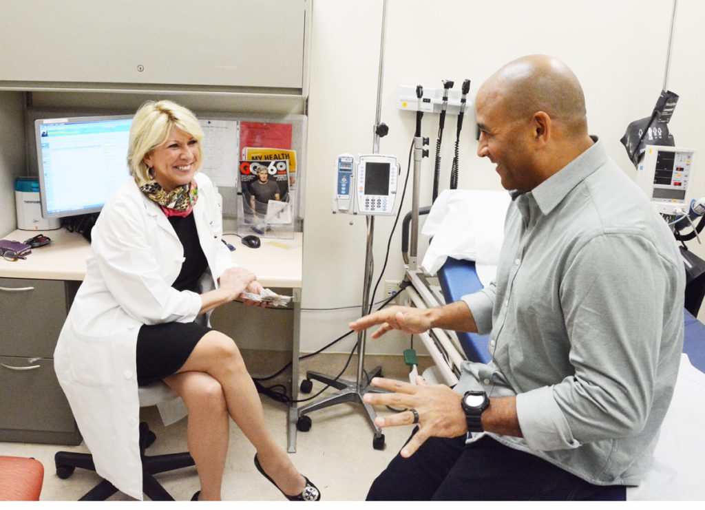 Dr. Pomfret is shown during a checkup with Jeff Bramstedt. Dr. Pomfret removed part of Bramstedt's liver so he could donate it to a young mother.
