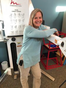 Patient Tia Mollander stands and shows off an insulin pump that she wears clipped to her right front pocket.