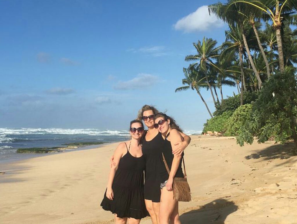Evelyn Schwandt poses on the beach in Hawaii with her two grown daughters.
