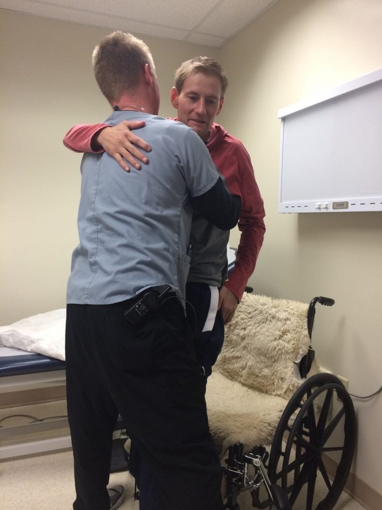 Archie hugs his physical therapist and rises from his wheel chair for the first time. The moment gave him hope that he would ride, rope and ranch again after a terrible head-on car crash.