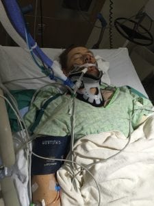Archie Chant in his hospital bed. He looks extremely sick and is on a ventilator. He managed to heal and now is riding, roping and ranching again.