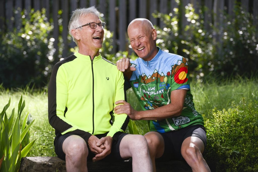 Jim Eastman left, and Scott La Point have bonded like brothers since La Point donated one of his kidneys to Eastman. Here they sit next to one another wearing cycling gear. They're laughing as they sit side by side.
