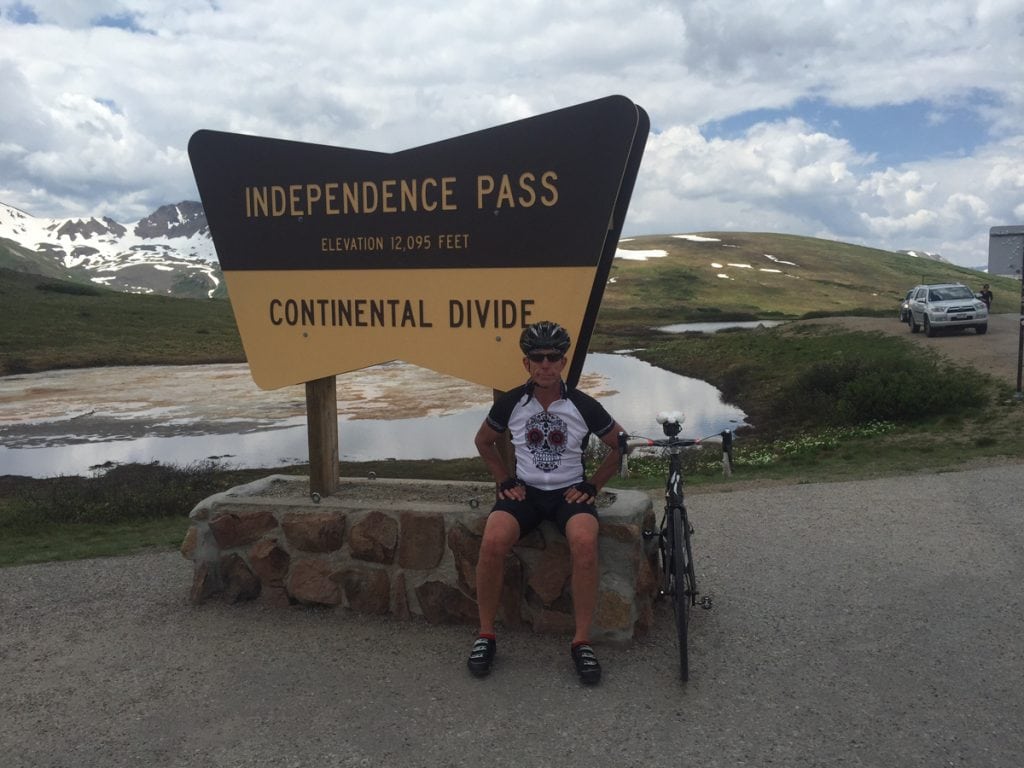 Rich Trostel poses at the summit of Independence Pass. The avid cyclist is back on his bike thanks to a partial knee replacement.