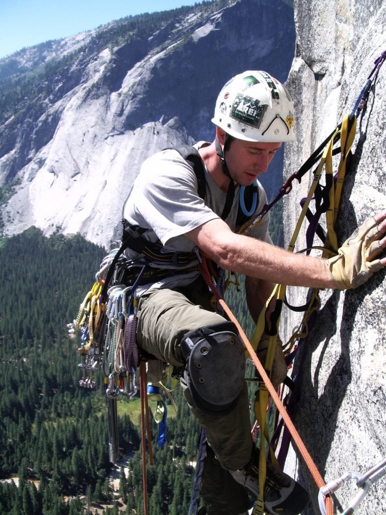 Dr. John Hall rock climbing.
