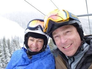 Trisha and Brian Washburn in a photo on a chairlift durign ski season. Both are ski instructors who moved to Colorado from Connecticut so they could ski the biggest mountains.