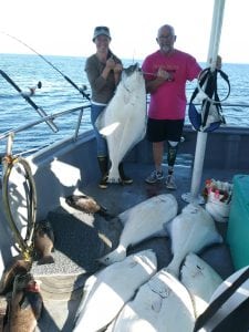 Stephanie and Jesse Adams show off their halibut catch during a recent trip to Alaska. Photo courtesy of Stephanie Adams.