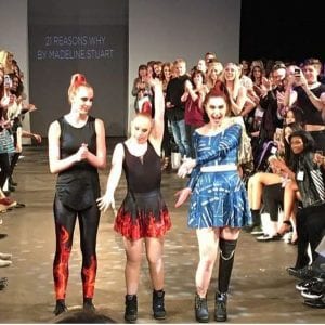 Three women model at a show. The middle one is a famous model with down syndrome named Madeline Stuart .The one on the right is Alina Miller, an amputee who has gotten a new leg and a new life.