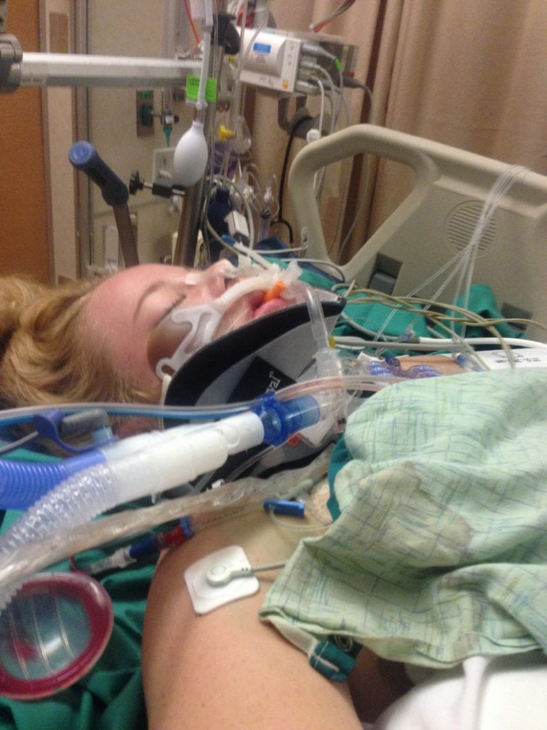 Devyn Brinkerhoff laying in her hospital bed. She was barely clinging to life at first after a bad accident.