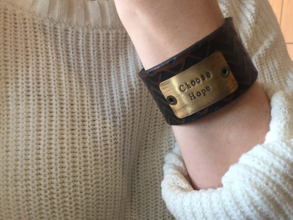 a woman shows her bracelet that says "Choose Hope." It's the mantra for moms who have lost their babies.