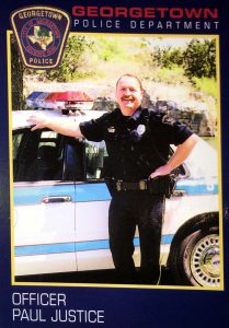 police officer standing in front of his police car