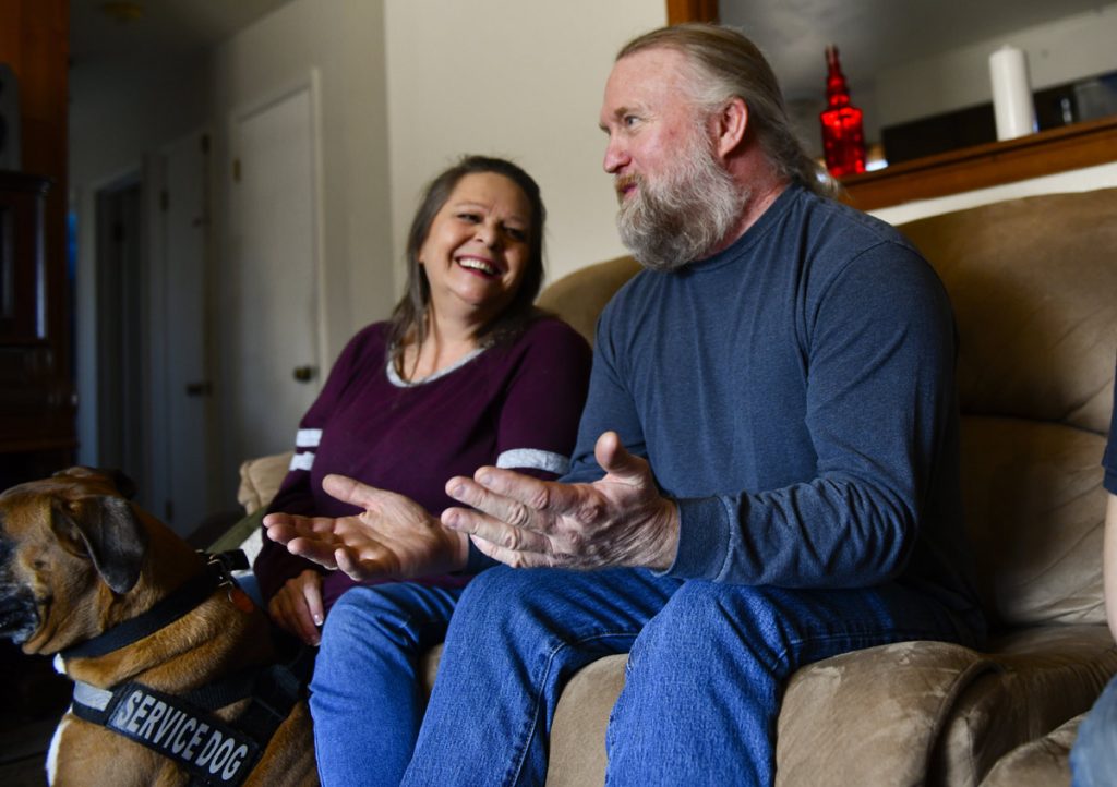 A woman gazes adoringly at her husband.