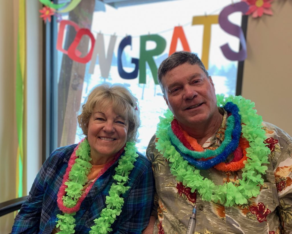 This is a photo of Connie Kassel and Bob Bryant following the surprise Hawaiian day at UCHealth Jan Bishop Cancer Center.