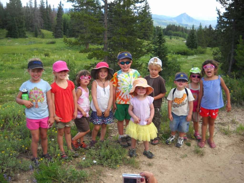 A big group of children camping together.